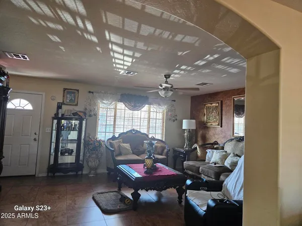 a living room with furniture and a chandelier