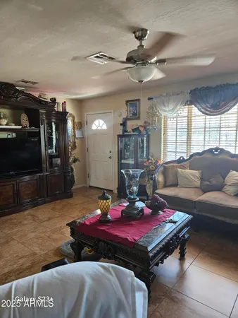 a living room with furniture pool table and a large window