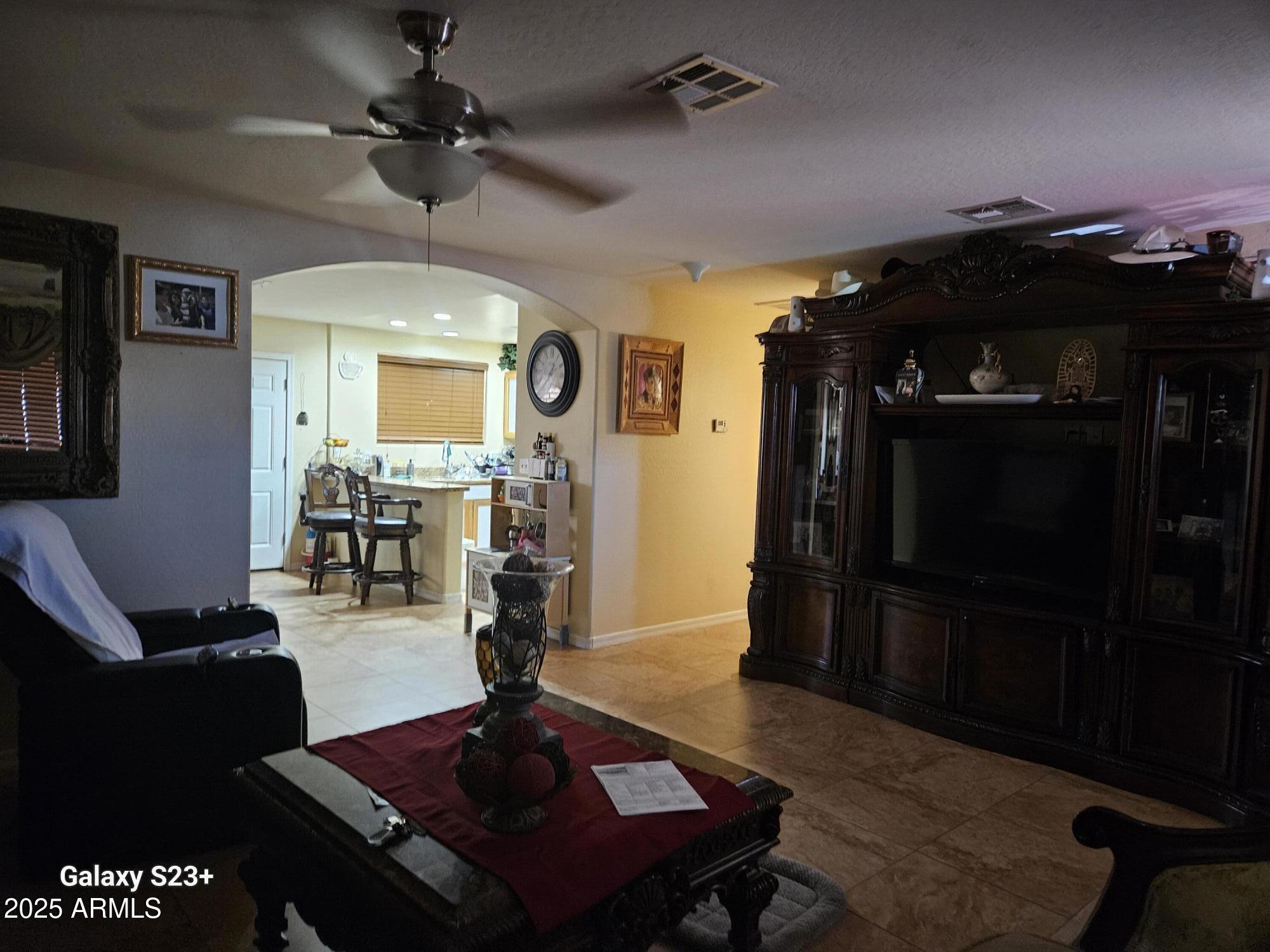 3020 North 40th Avenue Phoenix, AZ 85019 - Photo 25 of 36 a living room with furniture and a flat screen tv