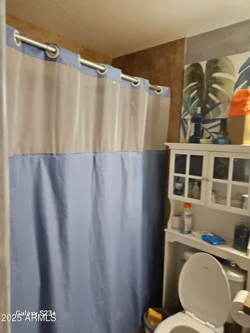 a bathroom with a toilet and shower