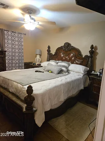 a bedroom with a bed and a chandelier