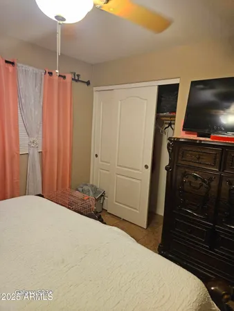 a bedroom with a bed and a flat screen tv