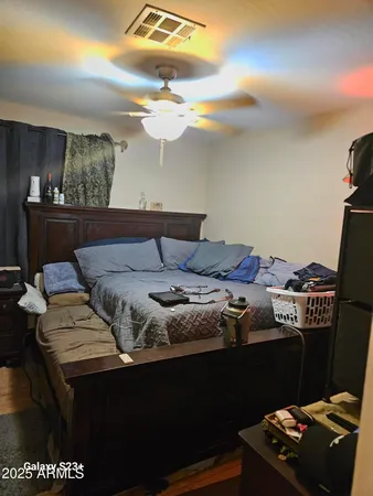 a bedroom with a bed and a night stand