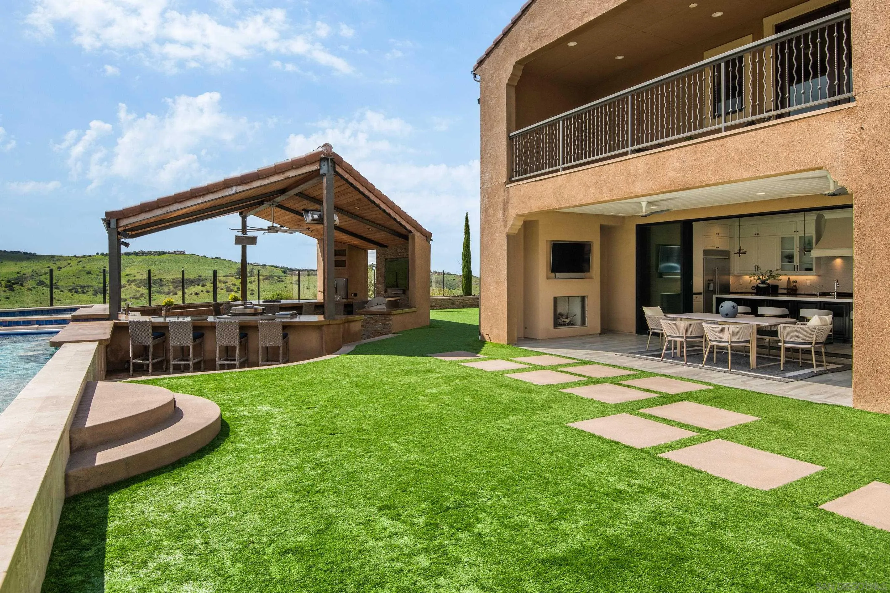 16339 Nicole Ridge Road San Diego, CA 92127 - Photo 13 of 56 a view of a house with a backyard porch and sitting area