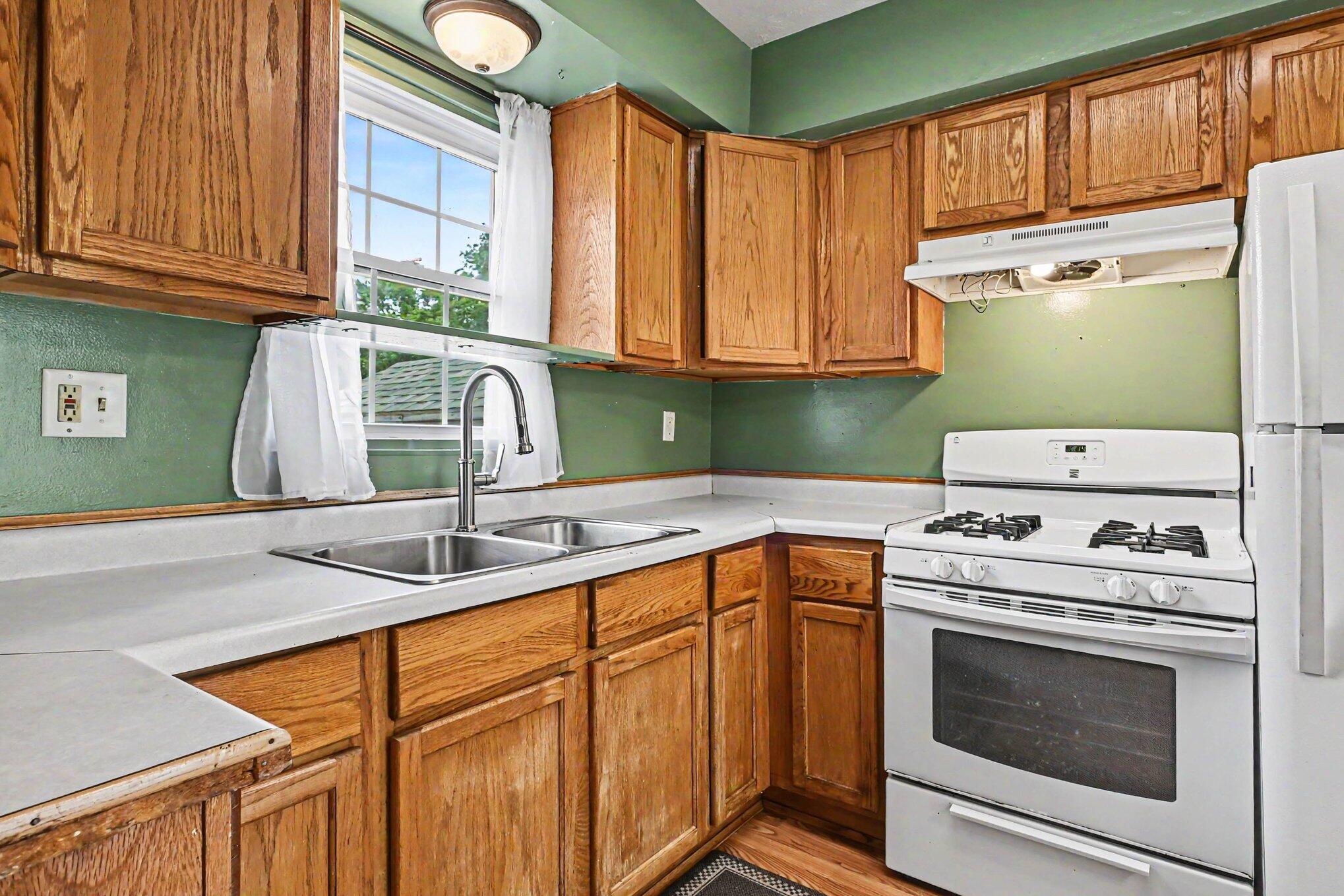 115 McClung Road La Porte, IN 46350 - Photo 6 of 31 a kitchen with a sink cabinets and window