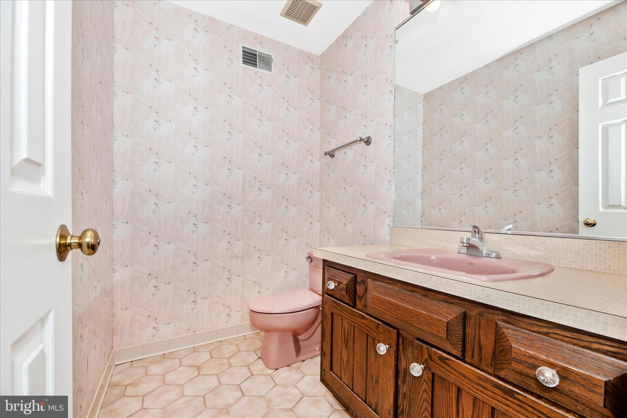 2221 Gold Mine Road Brookeville, MD 20833 - Photo 25 of 60 a bathroom with a granite countertop sink a toilet and mirror