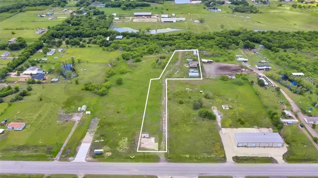 an aerial view of a residential houses with outdoor space