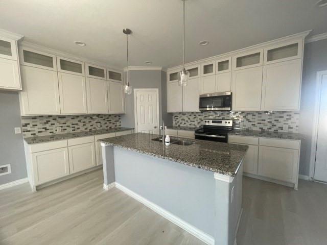 938 Genesis Road Rice, TX 75155 - Photo 5 of 13 a kitchen with granite countertop a sink stainless steel appliances and white cabinets
