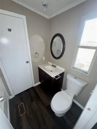 a bathroom with a toilet sink and mirror