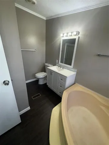 a bathroom with a sink toilet and mirror