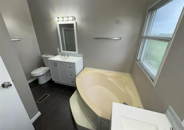 a bathroom with a toilet sink and mirror
