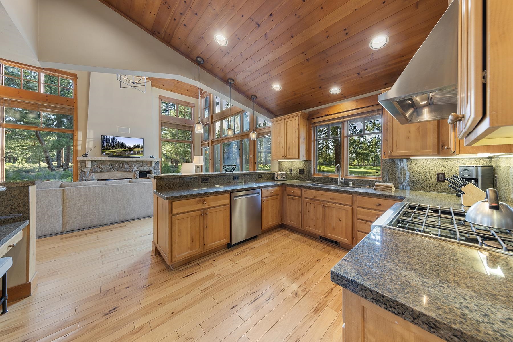 12323 Lookout Loop, Unit F1024 Truckee, CA 96161 - Photo 6 of 27 a kitchen with stainless steel appliances granite countertop wooden cabinets a stove a sink and a large window