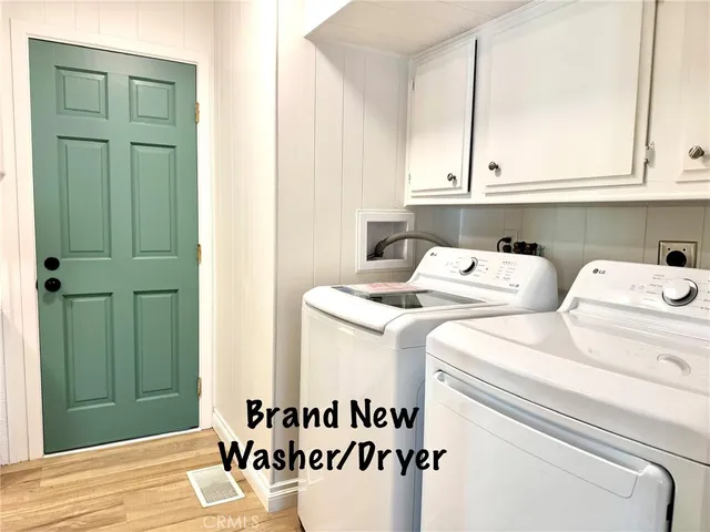 a view of empty room with window and wooden floor
