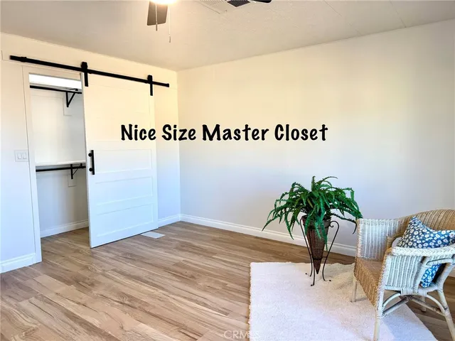 a view of an empty room with window and cabinet