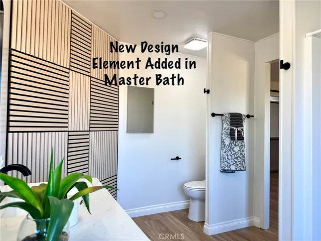 a living room with furniture a flat screen tv and kitchen view