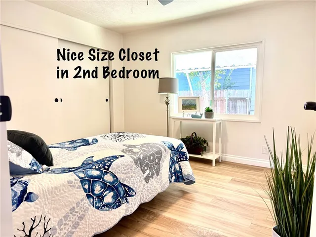 a bedroom with a bed and a night stand