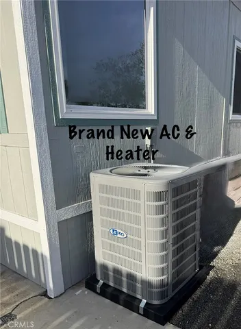 a view of backyard with a table and chairs and potted plants