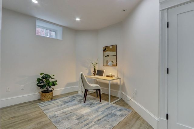 a workspace room with wooden floor table and chair