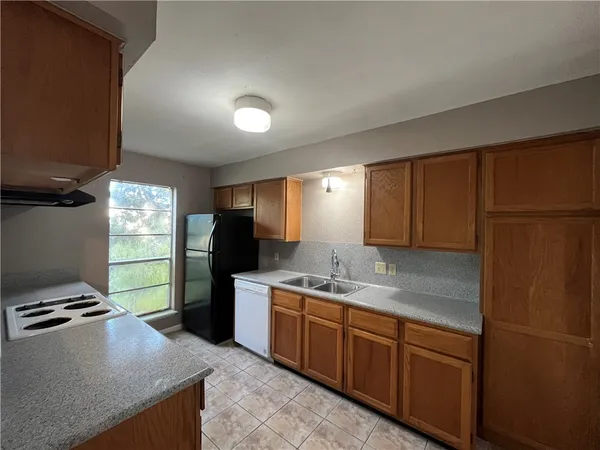 a kitchen with a refrigerator and a sink