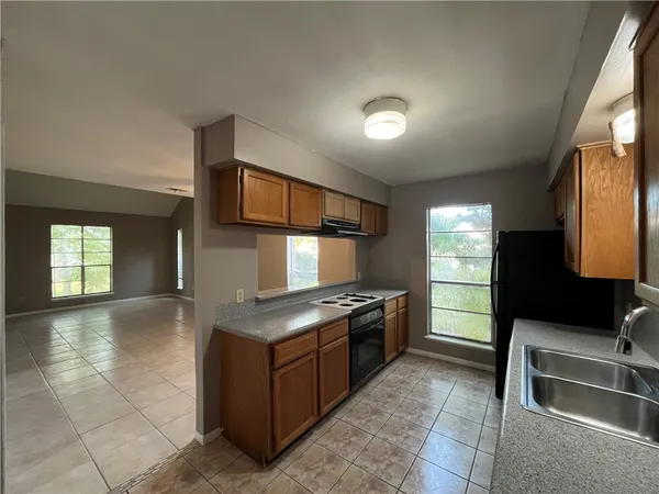 a kitchen with stainless steel appliances granite countertop a sink stove and cabinets