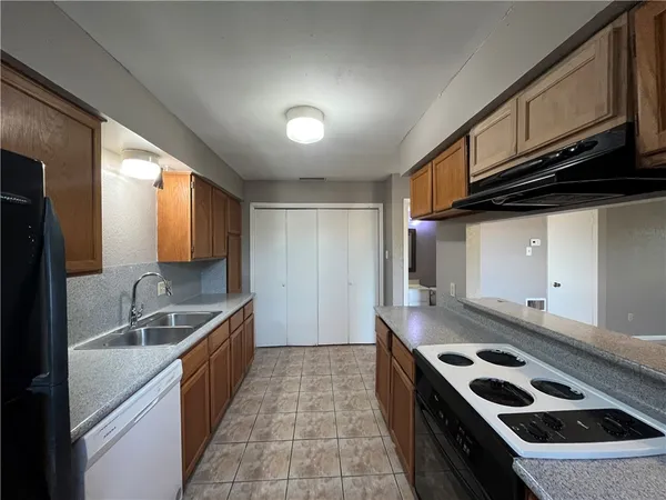 a kitchen with stainless steel appliances granite countertop a sink stove and cabinets