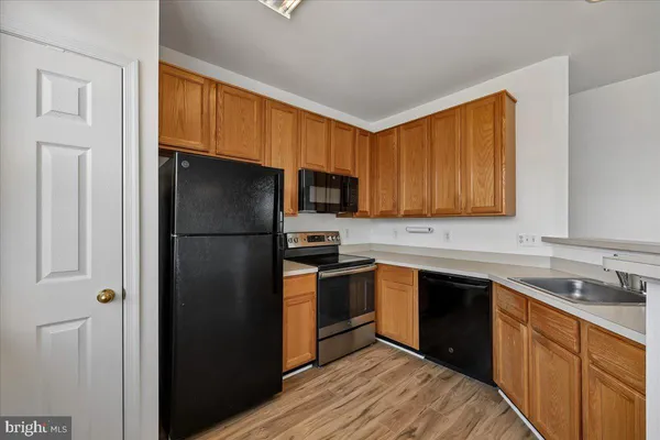a kitchen with a sink stove and refrigerator