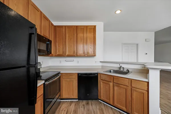 a kitchen with a sink stove and microwave
