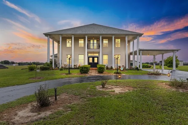 a view of a golf course with a swimming pool an outdoor space and lake view