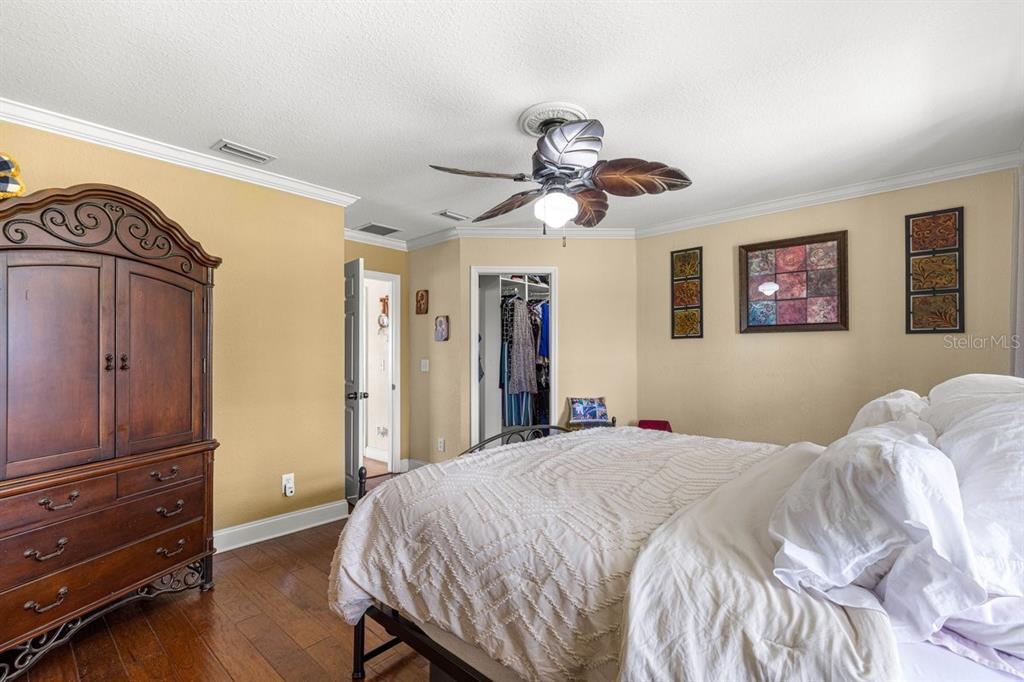 12345 Northeast 14th Avenue Anthony, FL 32617 - Photo 79 of 91 a bedroom with a bed and a chandelier