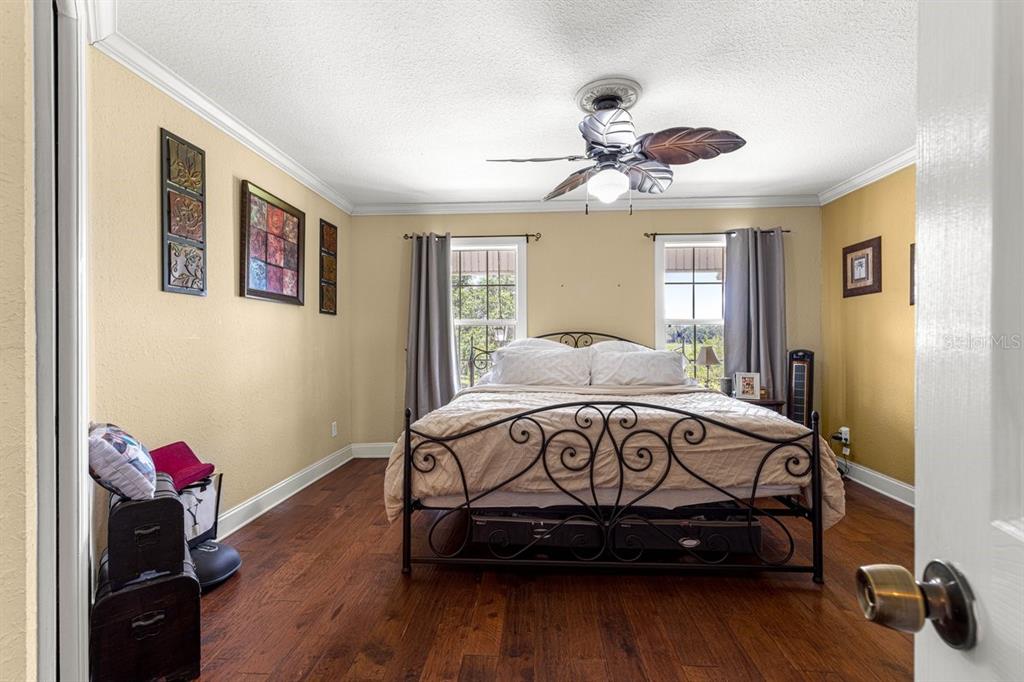 12345 Northeast 14th Avenue Anthony, FL 32617 - Photo 80 of 91 a bedroom with a bed and wooden floor