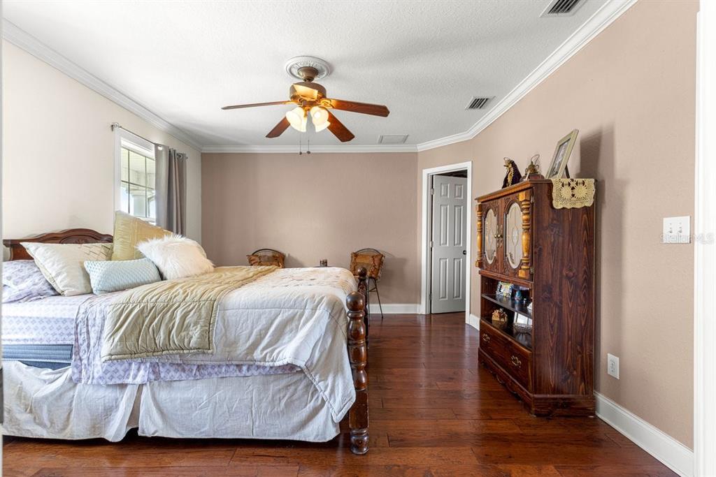 12345 Northeast 14th Avenue Anthony, FL 32617 - Photo 88 of 91 a bedroom with double bed and a chandelier