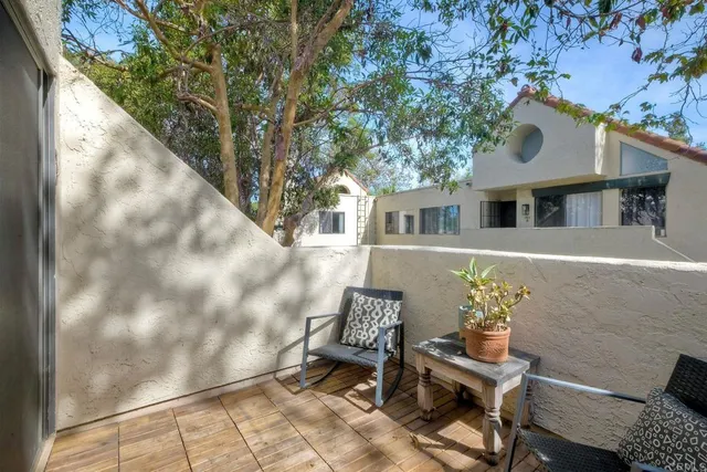 a kitchen that has a sink a microwave oven a stove and white cabinets with wooden floor