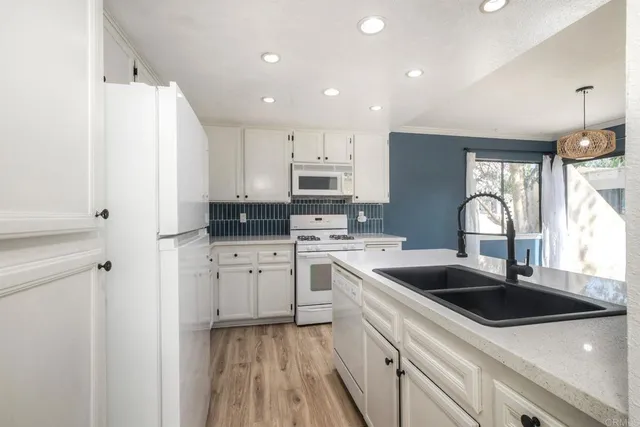 a view of kitchen with sink and wooden floor