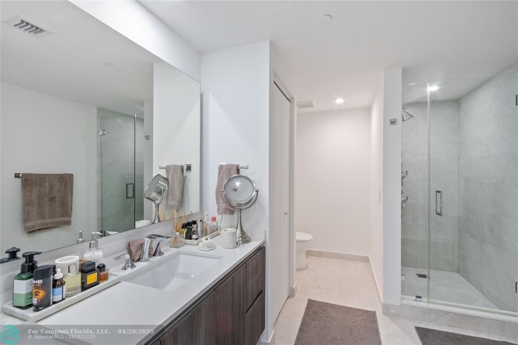 488 Northeast 18th Street, Unit 2010 Miami, FL 33132 - Photo 7 of 15 a bathroom with a double vanity sink mirror and shower