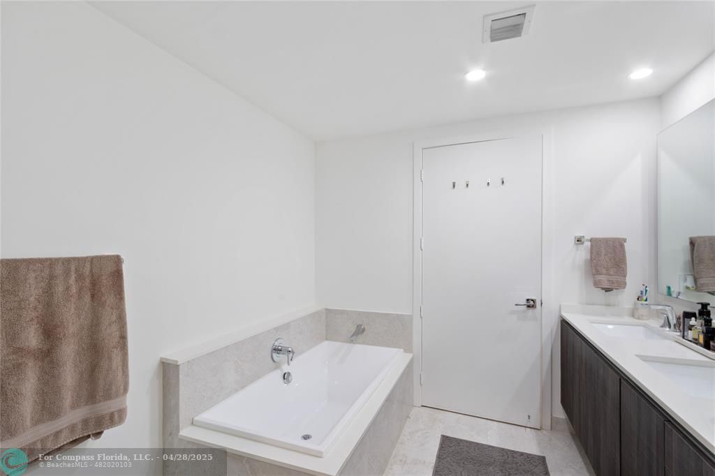 488 Northeast 18th Street, Unit 2010 Miami, FL 33132 - Photo 8 of 15 a bathroom with a tub sink and mirror