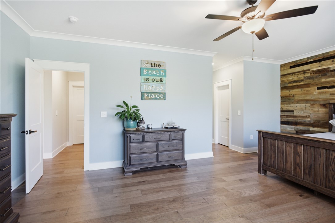 318 Summerall Drive Anderson, SC 29621 - Photo 18 of 42 This primary bedroom features elegant crown molding and rich hardwood flooring, creating a serene retreat.
