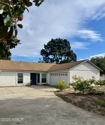 front view of a house with a dry yard