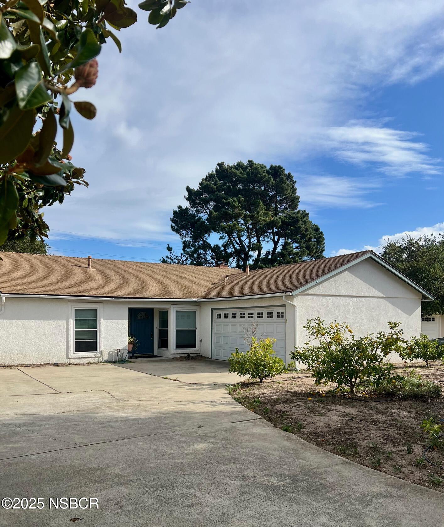 front view of a house with a dry yard
