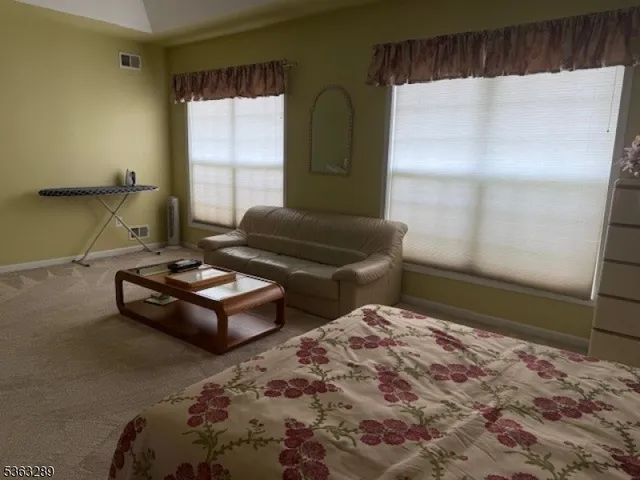a bathroom with a sink and mirror with bathtub