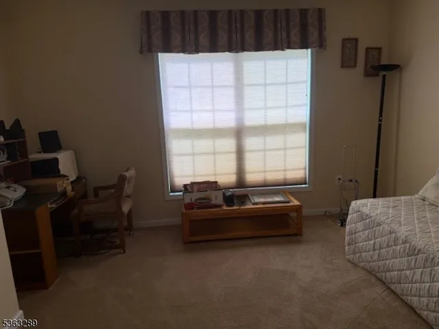 a view of hallway with a large mirror next to a window