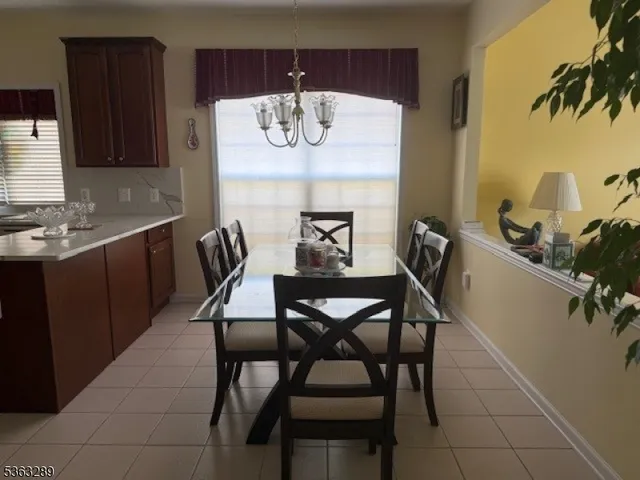 a living room with furniture a window and kitchen view