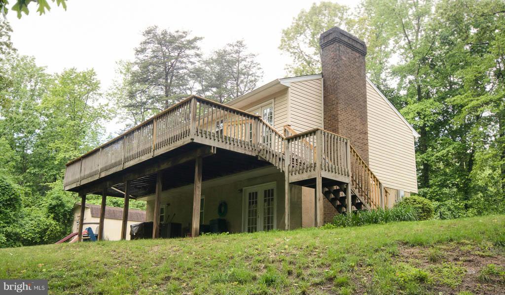 121 Plum Point Road Huntingtown, MD 20639 - Photo 22 of 30 a view of a house with a yard and balcony