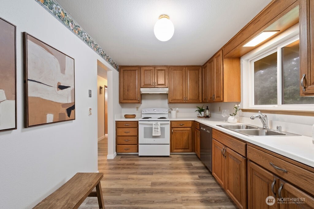 4813 208th Street East Spanaway, WA 98387 - Photo 15 of 39 a kitchen with a sink window and cabinets
