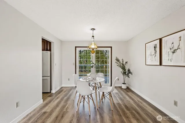 a view of a room with wooden floor windows and chandelier