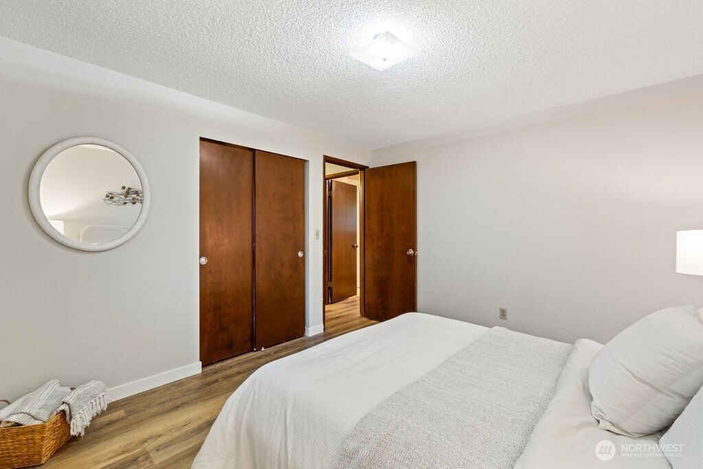 4813 208th Street East Spanaway, WA 98387 - Photo 17 of 39 a bedroom with a bed and a mirror
