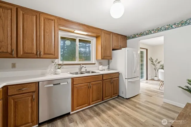 a kitchen with white cabinets and refrigerator