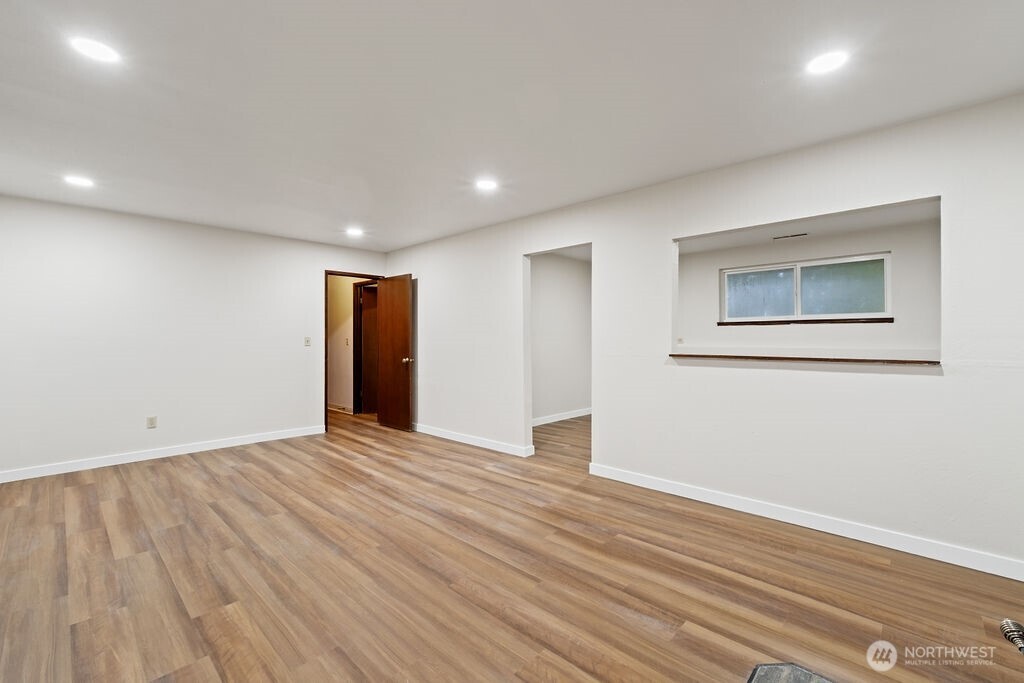 4813 208th Street East Spanaway, WA 98387 - Photo 27 of 39 a view of an empty room with wooden floor and closet