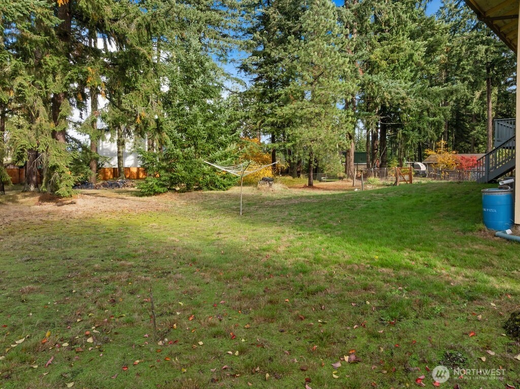 4813 208th Street East Spanaway, WA 98387 - Photo 37 of 39 a view of a field with trees in front of it
