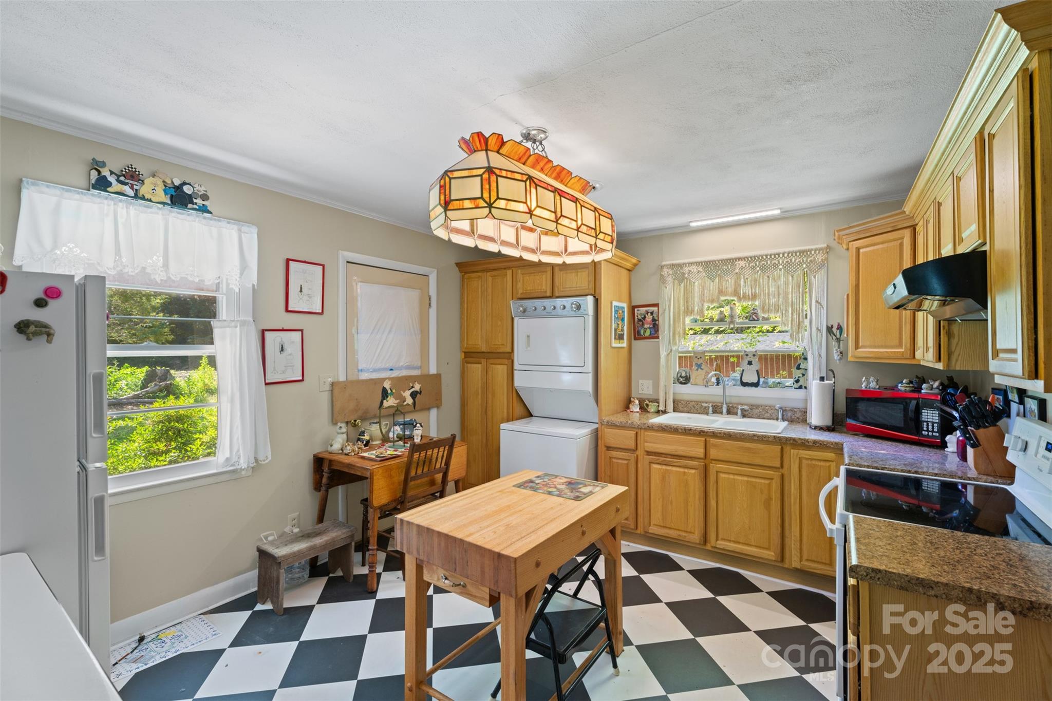25 Wall Road Tryon, NC 28782 - Photo 7 of 21 a kitchen with a sink a stove a dining table and chairs