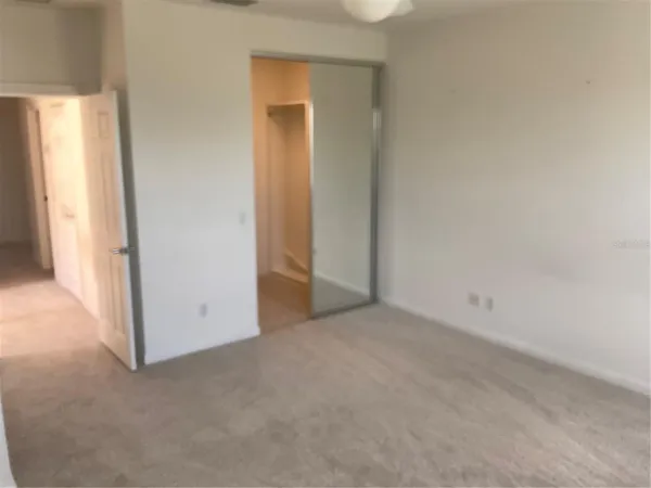 a view of an empty room and a window